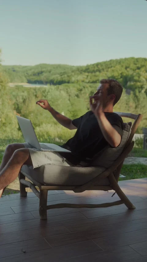 Man working remotely on laptop outdoors Stock Footage 297309957