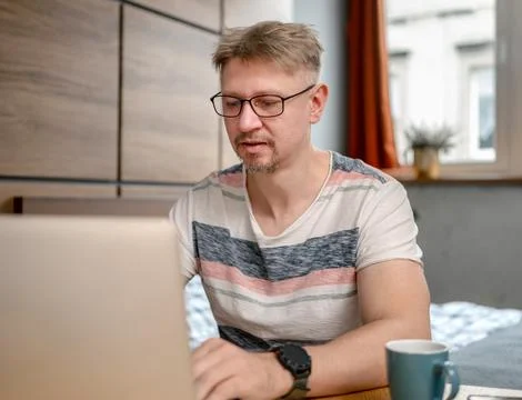 Man Working Remotely On Laptop Stock Photos