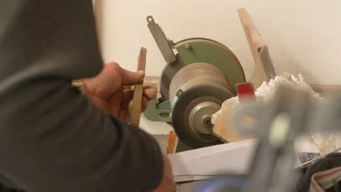 Man working with an sander to grind metal Stock Footage 132132290