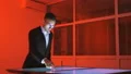 The man working with a sensor screen in a red room 4k or 4k+ Resolution