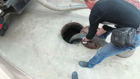 Man Working with Sewage Machine. Sucking Dirt Stock Footage 94865132