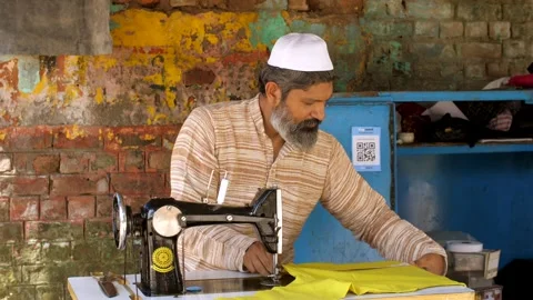 A man working on the sewing machine at his tailoring shop - earning concept, ... Stock Footage 260802656