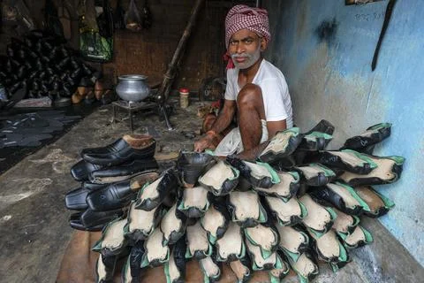 A man working in a shoe workshop Stock Photos