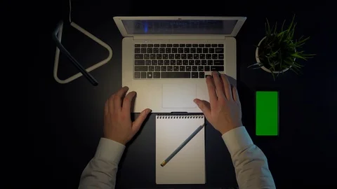 Man working sitting at the table using laptop and phone Stock Footage 102331935