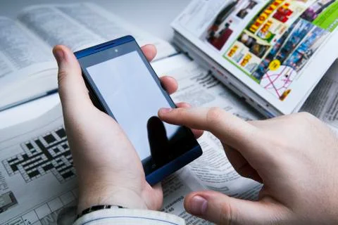 Man working on a smartphone in office Stock Photos