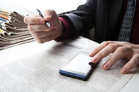 Man working on a smartphone in office 写真素材