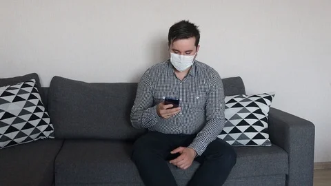 Man working with smartphone working from home office wearing mask Video stock 126711082