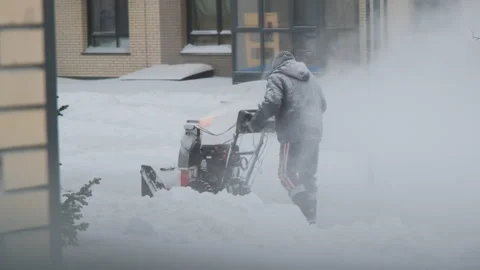 Man working with snowblower after winter storm Stock Footage 228798555