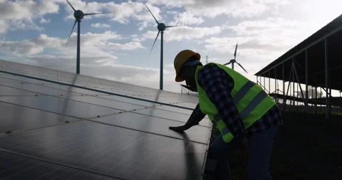 Man working for solar panels and wind turbines - Renewable energy Stock Footage 149302647