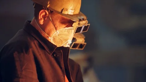 Man Working in a steel mill working in the hot manufacture Stock Footage 126054535