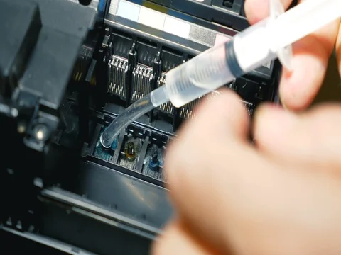 Man working with syringe to clean CMYK printer inkjet Stock Footage 69417075