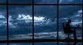 The man is working at the table near the windows in the business center Photo