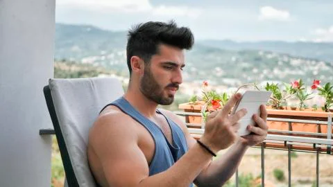 Man Working at Tablet Computer on Balcony Stock Photos