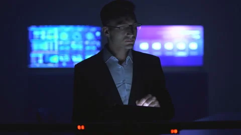 The man working with a tablet in the dark room Stock Footage 100371247
