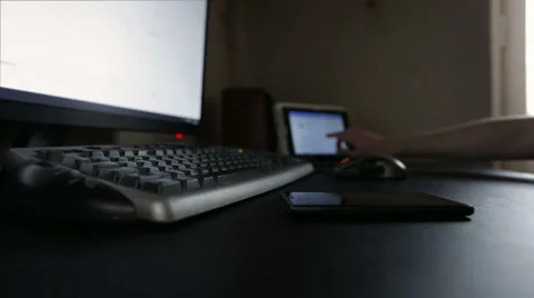 Man working with tablet, mobile device and PC, side view Stock Footage 48950859