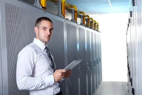 Man working with tablet  in a modern  server room Stock Photos