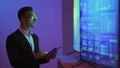 The man working with a tablet near the television 4k or 4k+ Resolution