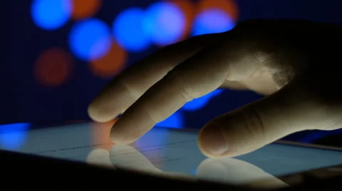 Man working for the Tablet PC on a background of Christmas lights Video stock 47752863