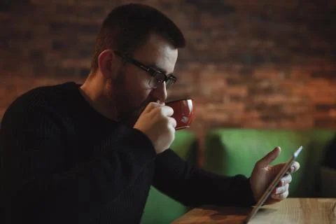 Man working at tablet PC in cafe Stock Photos