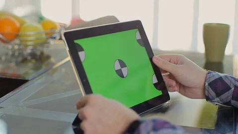 Man working on a tablet PC at home Stock Footage 73751627