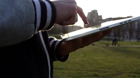 Man Working on a Tablet on The Sunset Background Stockbeeldmateriaal 64873857