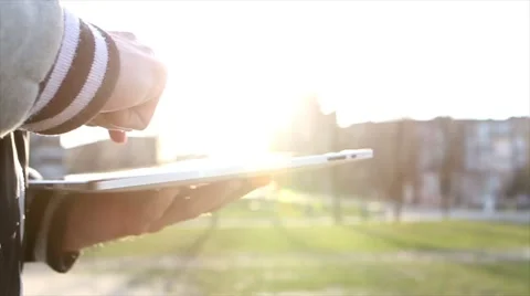 Man Working on a Tablet on The Sunset Background Stockbeeldmateriaal 64873875