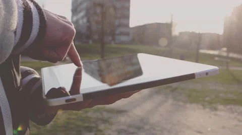 Man Working on a Tablet on The Sunset Background Stockbeeldmateriaal 64873923