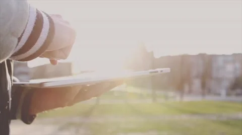 Man Working on a Tablet on The Sunset Background Stockbeeldmateriaal 64873932