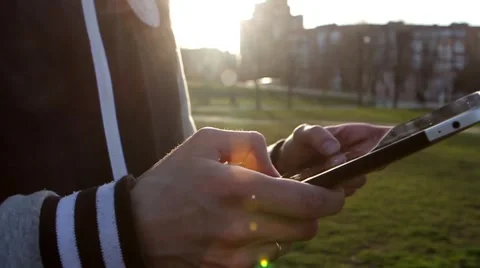 Man Working on a Tablet on The Sunset Background Stockbeeldmateriaal 64873939