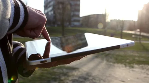 Man Working on a Tablet on The Sunset Background Stockbeeldmateriaal 64873958
