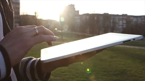 Man Working on a Tablet on The Sunset Background Stockbeeldmateriaal 64873993
