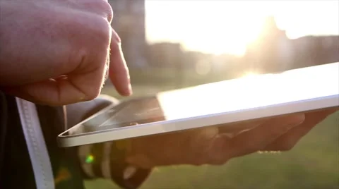 Man Working on a Tablet on The Sunset Background 動画素材 64873994