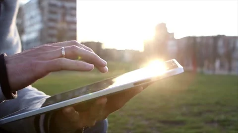Man Working on a Tablet on The Sunset Background Stockbeeldmateriaal 64874015