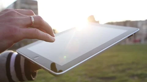 Man Working on a Tablet on The Sunset Background Stockbeeldmateriaal 64874024