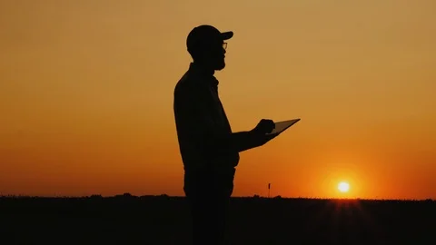 Man working with a tablet at sunset Stock Footage 113134359
