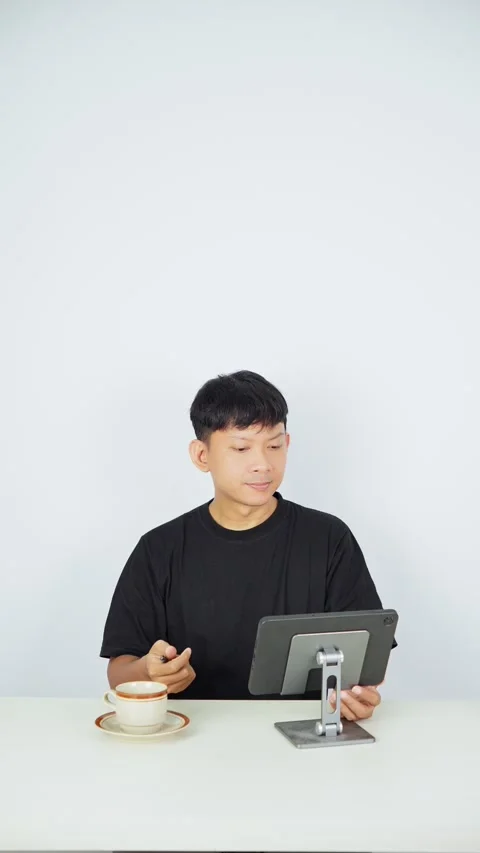 Man Working on Tablet While Drinking Coffee Stock-Footage 347105499