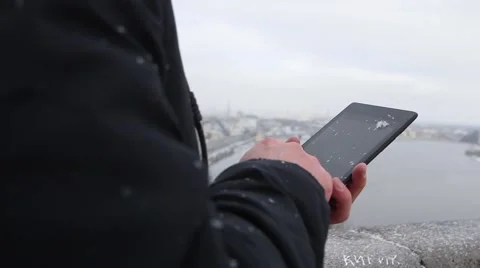 Man working on a tablet in the winter Stock Footage 59909982