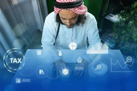 Man working on tax documentation with digital graphics in a modern office Stock Photos