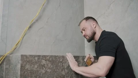 Man working with tile installation in slow motion during home renovation project Video stock 307041358