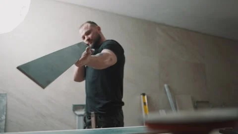 Man working with tile materials in slow motion Stock Footage 307039684