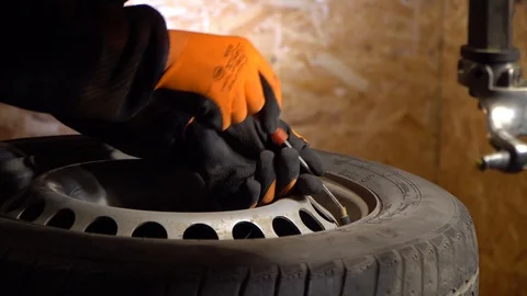 Man working tire mounting, working in garage Stock Footage 126506627