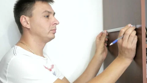 The man is working with a tool Stock Footage 95040942