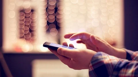 Man Working on the Touchscreen Mobile Phone on the Beautiful Bokeh Background Video stock 48675952
