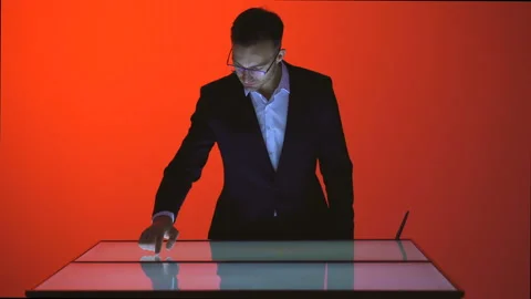 The man working with a touchscreen in the red room Video stock 100563746