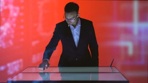 The man working with a touchscreen in the red room on the hologram background Stock Footage 100563837