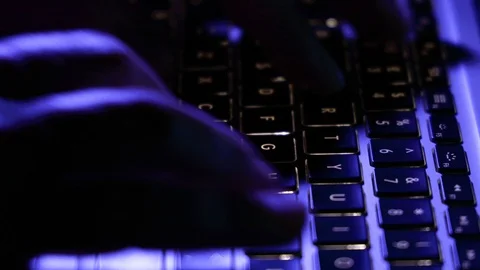Man working typing on computer keyboard at night with light on Stock Footage 105659452