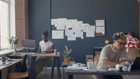 Man Working on UI Design of Mobile App Typing on Laptop at Office Desk Stock Footage 313933131