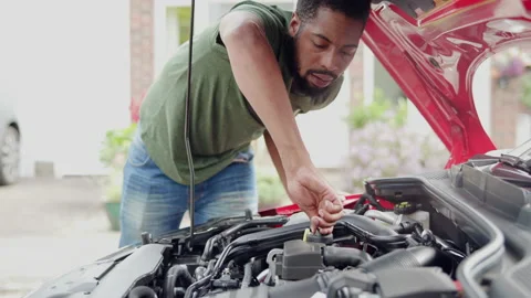 Man Working Under Open Car Hood Checking Engine Components Stock Footage 162486367