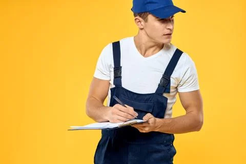Man in working uniform documents rendering of services delivery service yellow Stock Photos