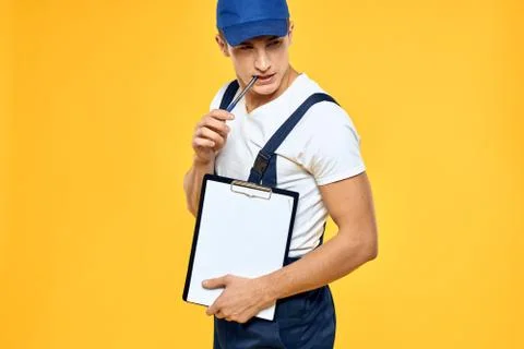 Man in working uniform documents rendering of services delivery service yellow Stock Photos